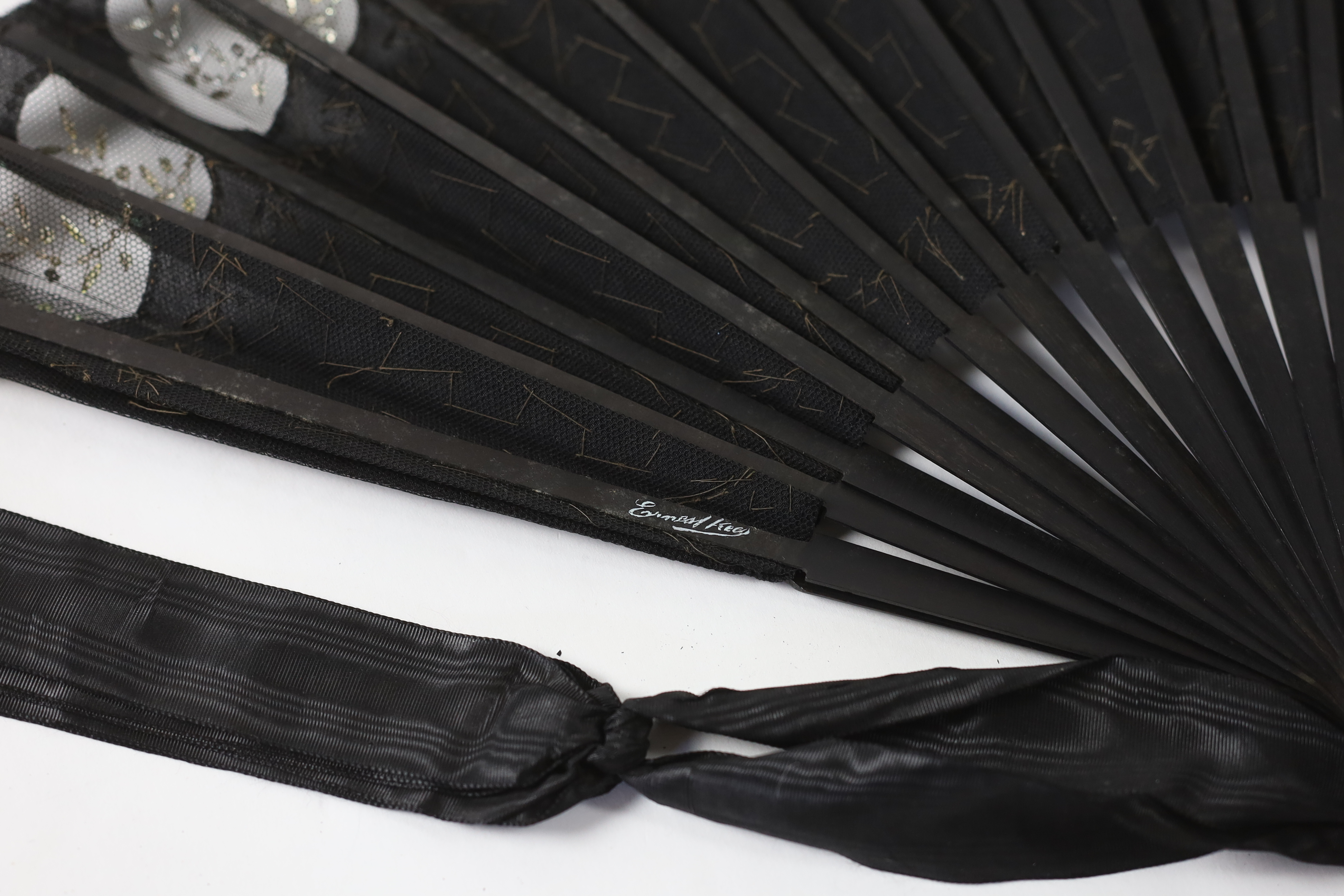 An Edwardian black silk and ornate sequin fan, a similar fan with carved ebony guards and a fine gauze fan with painted sprig and butterfly decoration (3)